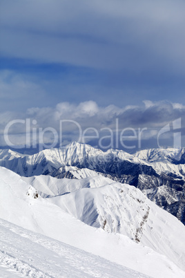 Ski slope and snowy mountains