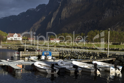 small harbor with mountains in background