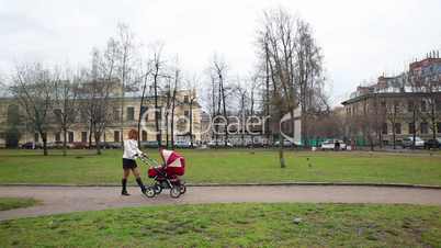 Mother WIth Baby Pram in Park