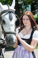 Woman in dirndl with horse