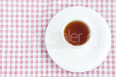 cup of tea on plaid fabric