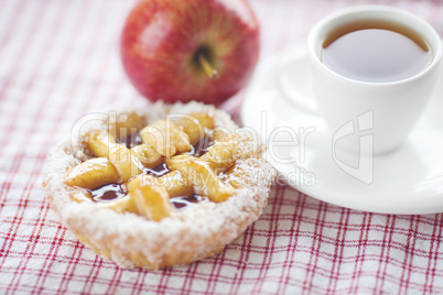 apple,beautiful cake with berries and tea on plaid fabric