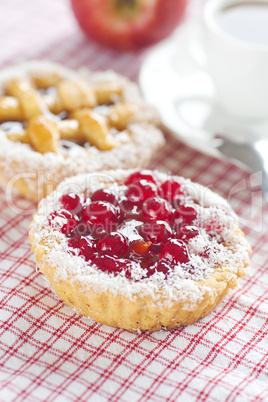 apple,beautiful cake with berries and tea on plaid fabric