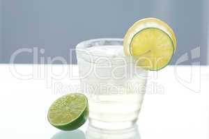 water with lemon and lime in a glass with ice