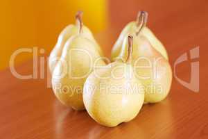 pears lying on a wooden table