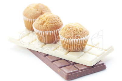 bar of chocolate and muffin isolated on white