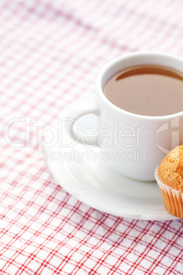 bar of chocolate and muffin on plaid fabric