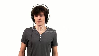 Young Man Listening To Music In Headphones. Isolated On White Background
