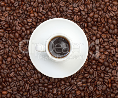 Cup with Hot Coffee on Coffee Beans