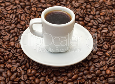 Cup with Hot Coffee on Coffee Beans