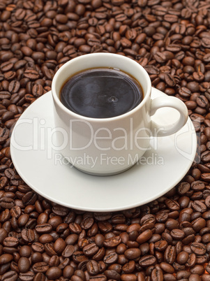 Cup with Hot Coffee on Coffee Beans