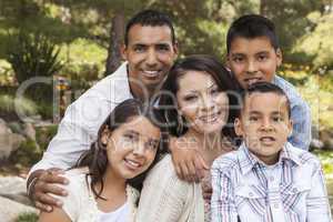 Happy Attractive Hispanic Family Portrait In the Park