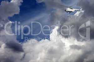 Helicopter in blue sky with clouds