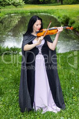 Woman playing violin in the park