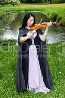 Woman playing violin in the park