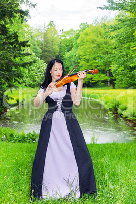 Woman playing violin in the park