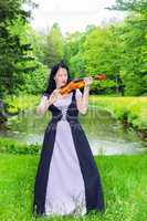 Woman playing violin in the park