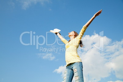 young woman staying with raised hands