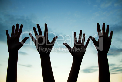 four raised hands