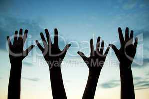 four raised hands