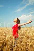 teen girl staying at a wheat field
