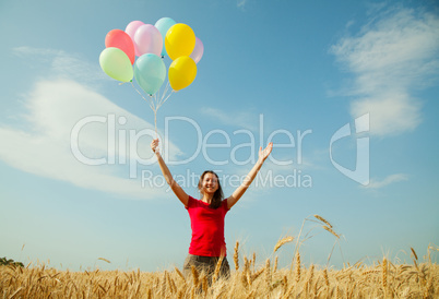 teen girl at a wheat field with colorful balloons