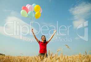 teen girl at a wheat field with colorful balloons