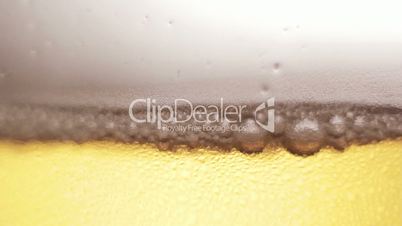 Pouring cold beer into glass