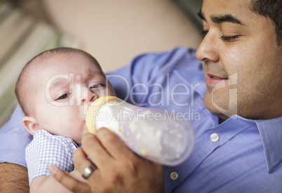 Happy Hispanic Father Bottle Feeding His Son