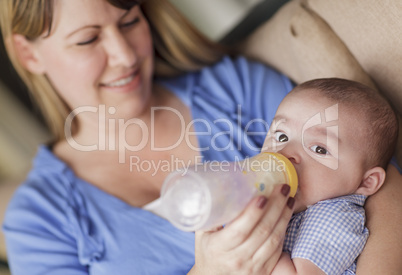 Happy Mother Bottle Feeding Her Son