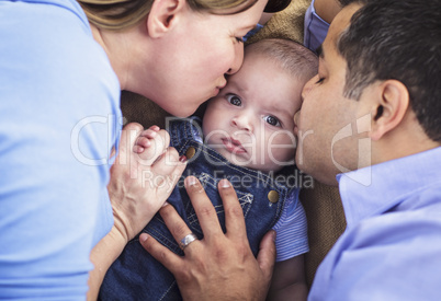 Mixed Race Parent Kissing Their Son