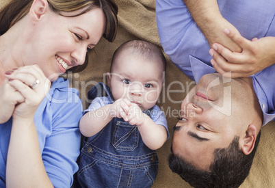 Mixed Race Family Playing on the Blanket