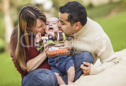 Happy Mixed Race Parents Playing with Their Son