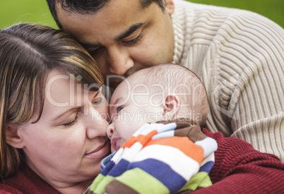 Happy Mixed Race Parents Hugging Their Son