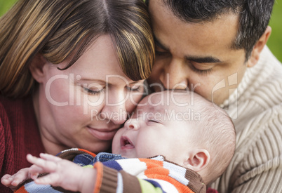Happy Mixed Race Parents Hugging Their Son