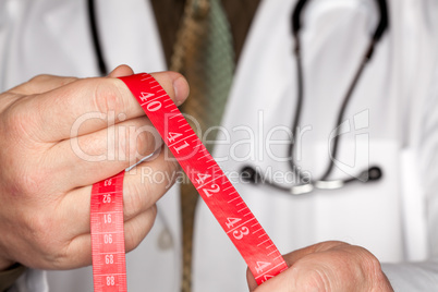 Doctor with Stethoscope Holding Measuring Tape