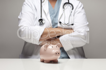 Doctor with Folded Arms Behind Piggy Bank