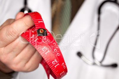 Doctor with Stethoscope Holding Measuring Tape