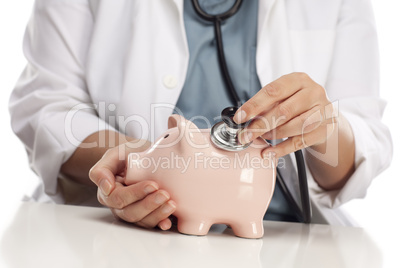 Doctor Holding Stethoscope to Piggy Bank