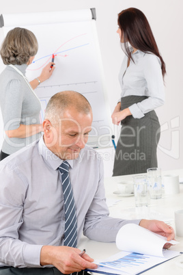 Giving presentation mature man during meeting