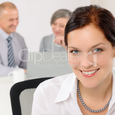 Smiling attractive businesswoman in office closeup