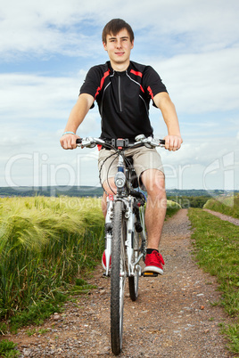 Young man riding a bicycle