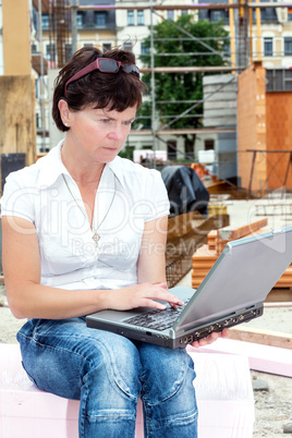 Civil engineer with a laptop on site