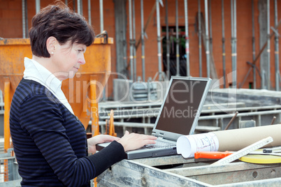 Civil engineer with a laptop on site