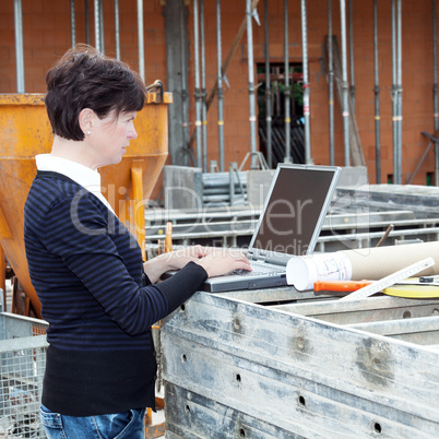 Civil engineer with a laptop on site