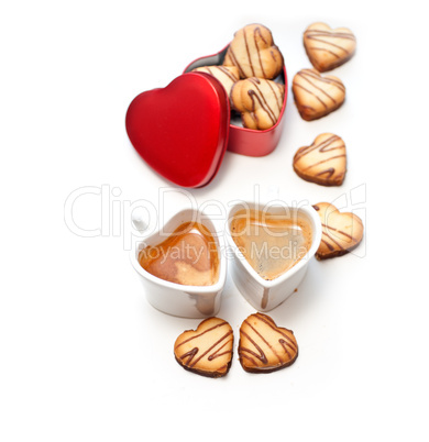 heart shaped cream cookies on red heart metal box and coffee