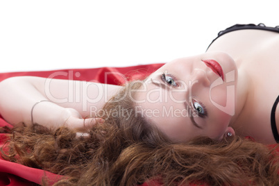 Woman lying on red sheet