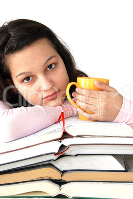 Teenage girl with books and cup