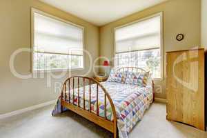 SImple guest bedroom with wood old bed.