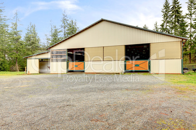 Horse arena exterior building with two lareg gates.